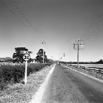 Cover image for Photograph - Ulverstone area, view of Forth Road (now Eastland Drive) showing house at 90 Eastland Drive and road sign showing speed limit of 30 m.p.h. and "Ulverstone"