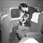 Cover image for Photograph - Cambridge Airport, hostess fastening seat belts