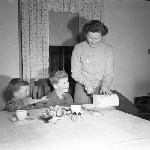 Cover image for Photograph - Mother cutting bread