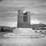 Cover image for Photograph - Collin's Monument of the sesquicentenary of the founding of Hobart Town by Colonel David Collins, with Elizabeth Street pier in background, Hunter Street, Hobart.