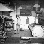 Cover image for Photograph - Haywoods Biscuit Factory, removing trays of Snax from oven