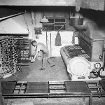 Cover image for Photograph - Haywoods Biscuit Factory, removing trays of Snax biscuits from oven