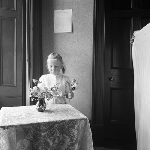 Cover image for Photograph - Little girl arranging flowers