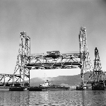 Cover image for Photograph - Tugboat with barges from APPM Boyer passing under the Bridgewater Elevator bridge