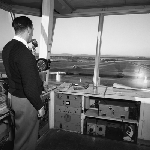 Cover image for Photograph - Llanherne (now Hobart) Airport, Control Tower, Control officers gives plane runway number