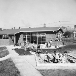 Cover image for Photograph - Campbell Street Pre-School, children playing outside school building