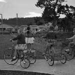 Cover image for Photograph - Bellerive Pre-School, children on tricycles on path