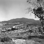 Cover image for Photograph - The Tasman Bridge, under construction with the city of Hobart and Mt. Wellington in the distance