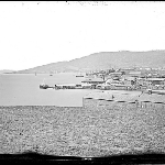 Cover image for Photograph - View of Hobart taken from the Domain in 1857 by J Sharp. HMS Havannah and HMS Meander written on side of the buildings