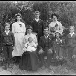 Cover image for Photograph - Family portrait [man and woman seated, with six children and woman]