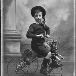 Cover image for Photograph - Boy riding bicycle [horse bicycle]