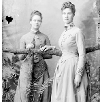 Cover image for Photograph - Miss Ash [two women posing for studio portrait, leaning on branch] [glass plate]