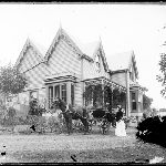 Cover image for Photograph - unidentified house [large weatherboard with gabled roof, decorative barge boards, verandah showing horse and cart and people in garden] [glass plate]