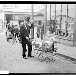 Cover image for Photograph - Man with 'baby' in a pram to advertise the movie 'The Bachelor's baby' aug 1927 [glass plate negative] [His Majestys Theatre, Liverpool Street]