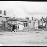 Cover image for Photograph - North Hobart corner store [shows Thomas Roberts store "The Clock Tower" and advertising for IXL Jam and Primrose soap (later Palfreyman's corner  - corner Burnett and Elizabeth Street.)] [glass plate]