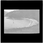 Cover image for Photograph - glass lantern slide - unidentified sandy beach and cove with jetty