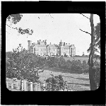 Cover image for Photograph - glass lantern slide - Hobart - Domain - Government House - exterior view - shows gardens and part of picket fencing