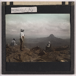 Cover image for Photograph - Climbers on top of Cradle Mountain looking toward Barn Bluff (hand-coloured) / Fred Smithies [lantern slide]