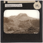 Cover image for Photograph - Panoramic mountain view - Cradle Mountain from end on, Little Horn obscured by the bulk of the mountain / Fred Smithies [lantern slide]