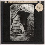 Cover image for Photograph - Waldheim, Cradle Mountain -  hut called 'the Chapel' with woman on front step / Fred Smithies [lantern slide]