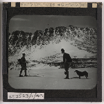 Cover image for Photograph - Gustav Weindorfer and dog and Frederick Smithies walking -  in the snow at Cradle Plateau / Fred Smithies [lantern slide]