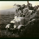 Cover image for Photograph - View of motor vehicle Citroen Kegresse c 1925 off-road in open countryside loaded with passengers [35mm transparency copy of Frederick Smithies' original 3" x 3" glass slide accidentally damaged beyond satisfactory repair"]