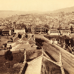 Cover image for Photograph - Panoramic view of Hobart from Holy Trinity tower- shows Church Street and Patrick Street buildings and details of St Andrew's burial ground and city centre in background.