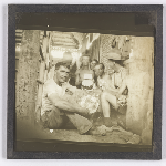 Cover image for Photograph - Glass slide - Army days - Workers [men holding metal bowls sitting inside building]