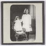 Cover image for Photograph - Glass slide - Girl with doll in chair