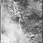 Cover image for Photograph - Negative - Waterfall [three men sitting beside waterfall]