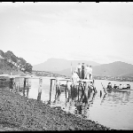 Cover image for Photograph - Glass negative - Parish picnic - [Group on jetty and in dinghy on Derwent River - Mt Wellington in background]