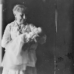 Cover image for Photograph - Negative - Older woman holding grandchild [grandmother ?]