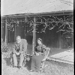 Cover image for Photograph - Negative - Unidentified older man and woman, seated outside house