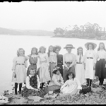 Cover image for Photograph - Glass negative - Parish picnic [Group of young girls and women on rocky foreshore]