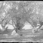 Cover image for Photograph - Glass negative - Parish picnic [two women sitting beside river]
