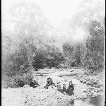 Cover image for Photograph - Glass negative - Farm [Group sitting beside stream - unidentified area]