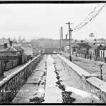 Cover image for Photograph - The Rivulet Hobart (144 new series) [Lower Collins Street - looking east shows Terminus Hotel] / photographer W J Little [glass plate negative]