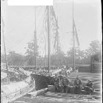 Cover image for Photograph - Unidentified [mensitting on wharf near ships]
