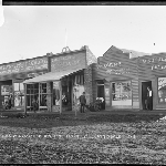 Cover image for Photograph - Main Street, Scottsdale showing shop fronts [TGR Williams General Store, Henderson Drapery, FW Loone Watchmaker and Jeweller, H Sutherland, Tailor]
