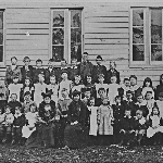 Cover image for Photograph - Photographic portrait of teachers and students at the Southport State School, the teacher with the feather boa is WESLEY, Flora, Miss