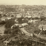 Cover image for Photograph - Launceston - view from Trevallyn Bridge showing toll house near Gorge and old Launceston Gaol in background