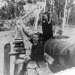Cover image for Photograph - Copy of photograph of Ruth and Joan Cecil on syphon on the river at Ringarooma.