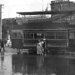 Cover image for Photograph - Tasmanian Tourist Bureau - corner Macquarie and Elizabeth Streets. Showing double decker tram. (Original negative only-size 13cm x 9cm-Print made from negative).