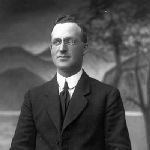 Cover image for Photograph - Man-unidentified-wearing suit and glasses.