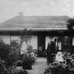 Cover image for Photograph - John and Clara Harding with baby, John William, outside residence at Government Farm, New Town