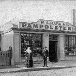 Cover image for Photograph - Shop - "M A Harding. Pampoleterion". Window shows drapery and general wares. Unidentified location.