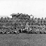 Cover image for Photograph - Soldiers with officers in front of house and tents