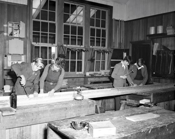 4 boys making a tin gutter