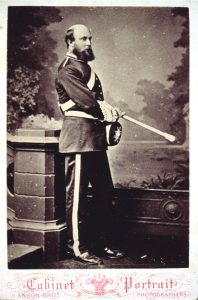 A black and white photo of a man in an officers' uniform posing for a photo.