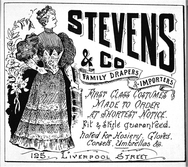A newspaper clipping of a black and white line drawing advertising clothing.  A lady stands beside a chair wearing a full-length dress with corset, full skirt and puffy selves. Text on the page reads: “Stevens and Co Family drapers and importers. First class costumes made to order at shortest notice. Fit and style guaranteed. Noted for hosiery, gloves, corsets, and umbrellas etc. 125. Liverpool street.”